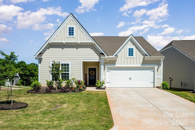 craftsman inspired home with board and batten siding, roof with shingles, a front yard, concrete driveway, and an attached garage