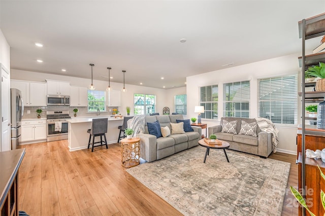 living room featuring recessed lighting and light wood-type flooring