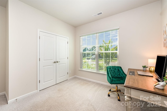 office space featuring baseboards, carpet, and visible vents