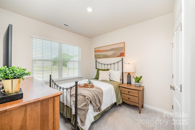 bedroom with baseboards, light colored carpet, recessed lighting, and visible vents
