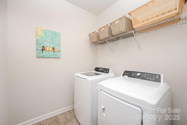 laundry room featuring light tile patterned floors, baseboards, laundry area, and washing machine and dryer