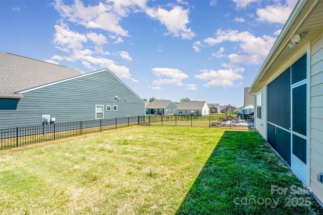 view of yard featuring a residential view and a fenced backyard