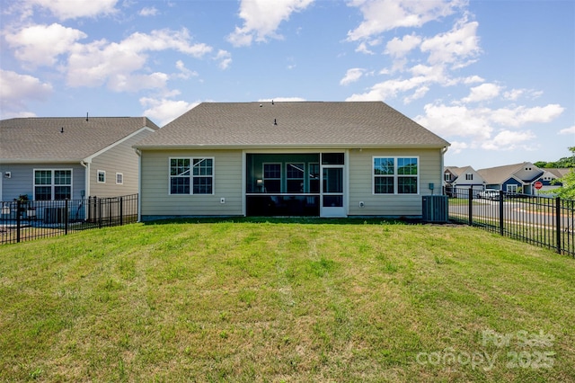 back of property with a lawn, a fenced backyard, central air condition unit, and a sunroom