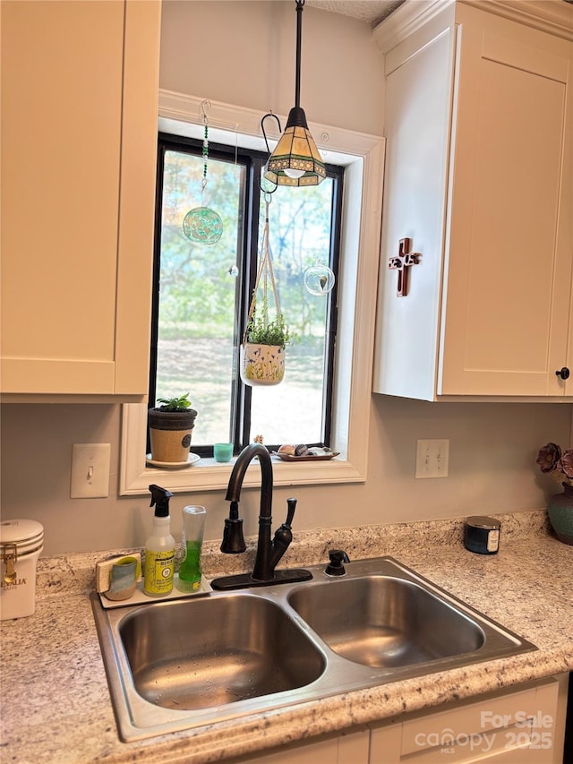 details featuring light countertops, white cabinetry, and a sink