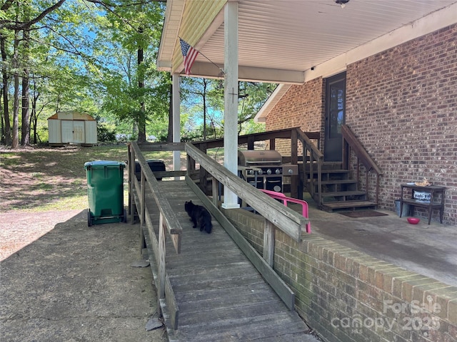exterior space featuring an outdoor structure, a shed, and area for grilling