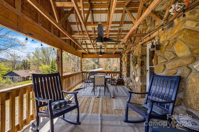 deck with ceiling fan and outdoor dining area