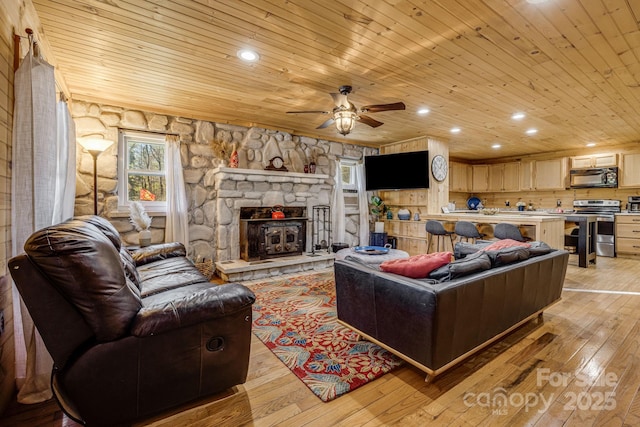 living room featuring ceiling fan, recessed lighting, wooden ceiling, and light wood-style floors