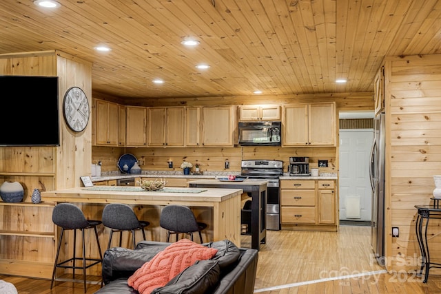 kitchen with stainless steel appliances, light countertops, light brown cabinets, and wooden ceiling