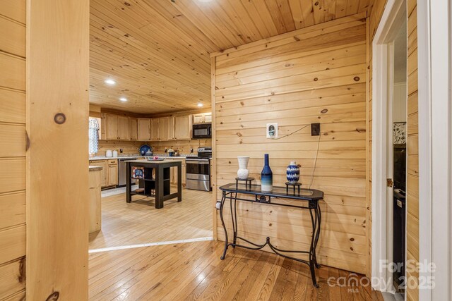 interior space featuring wood walls, recessed lighting, light wood finished floors, and wooden ceiling