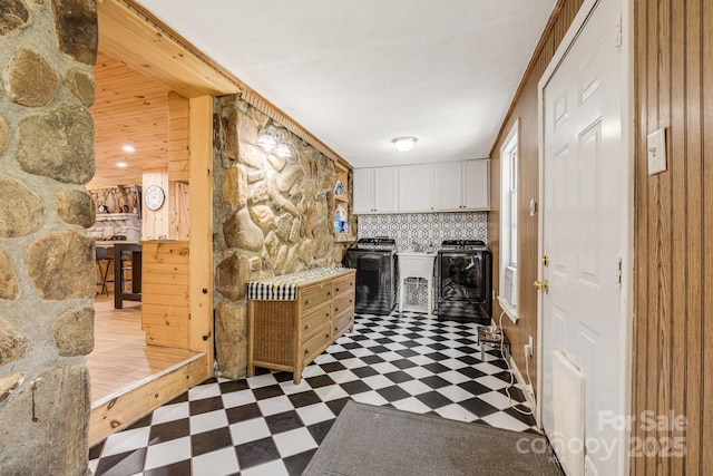 hall featuring tile patterned floors and separate washer and dryer