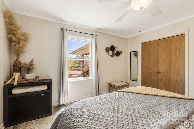 bedroom featuring a decorative wall, ceiling fan, ornamental molding, and wood finished floors