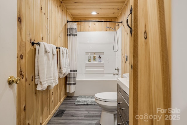 full bath featuring shower / bathtub combination with curtain, vanity, visible vents, toilet, and wood finished floors