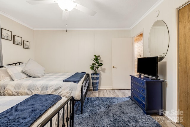 bedroom with crown molding, ceiling fan, and wood finished floors