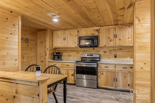 kitchen featuring stainless steel range with electric stovetop, black microwave, light brown cabinets, and wooden ceiling