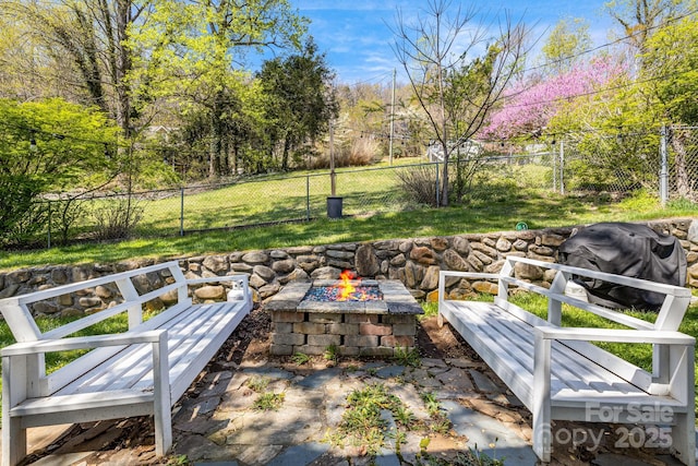 view of yard with an outdoor fire pit and a fenced backyard