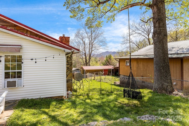 view of yard featuring a mountain view and fence