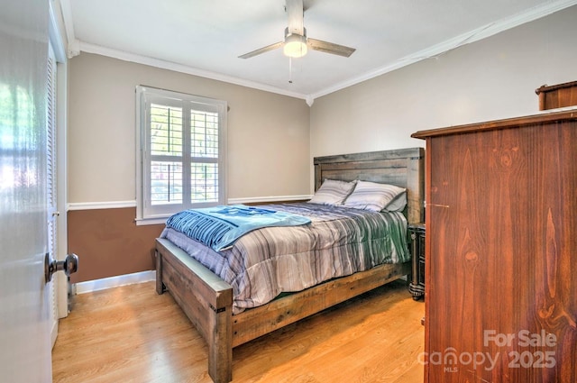 bedroom featuring baseboards, ornamental molding, and wood finished floors