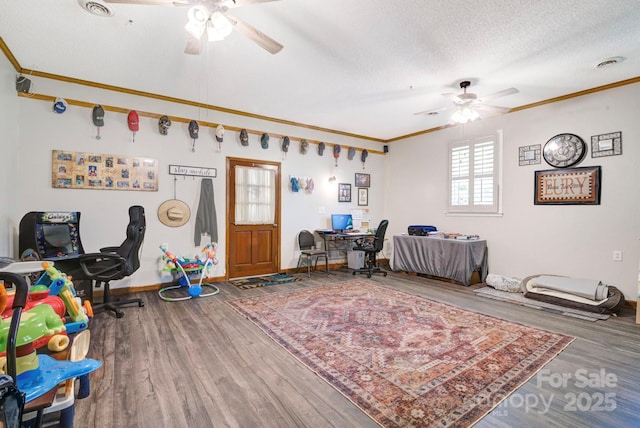 playroom with wood finished floors, a textured ceiling, a ceiling fan, and ornamental molding