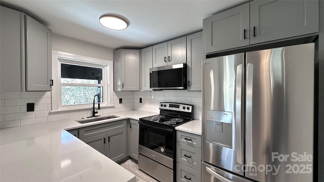 25 Dew Waite Rd, Black Mountain, NC 28711 - kitchen with stainless steel appliances, light countertops, a sink, decorative backsplash, and gray cabinetry