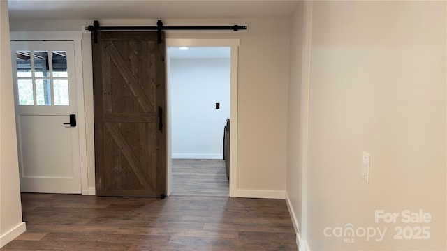 25 Dew Waite Rd, Black Mountain, NC 28711 - empty room with baseboards, dark wood-style flooring, and a barn door