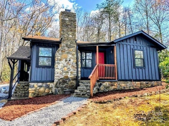 25 Dew Waite Rd, Black Mountain, NC 28711 - view of front facade with a chimney, stone siding, board and batten siding, and a shingled roof