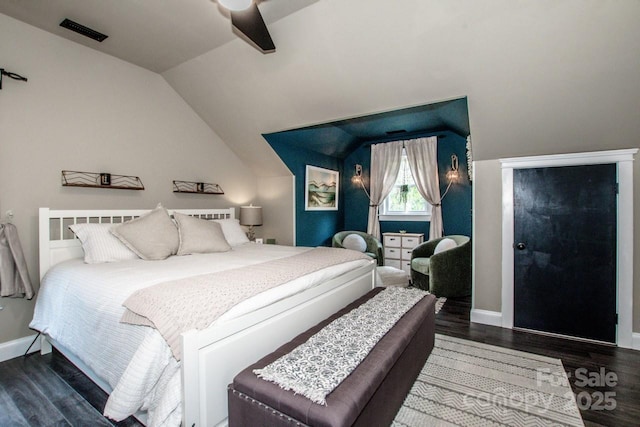 bedroom featuring visible vents, baseboards, vaulted ceiling, and wood finished floors