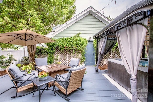wooden deck with fence and an outdoor fire pit
