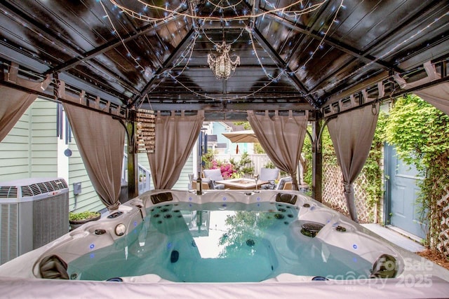 exterior space with cooling unit and a hot tub