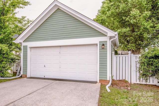 detached garage featuring fence