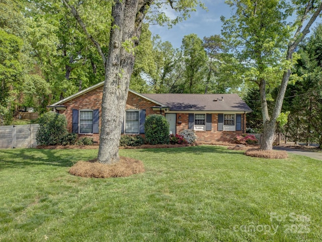 ranch-style house featuring brick siding and a front yard