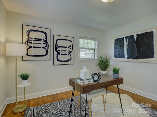 home office with wood finished floors and baseboards