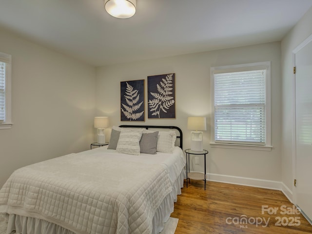 bedroom with wood finished floors and baseboards