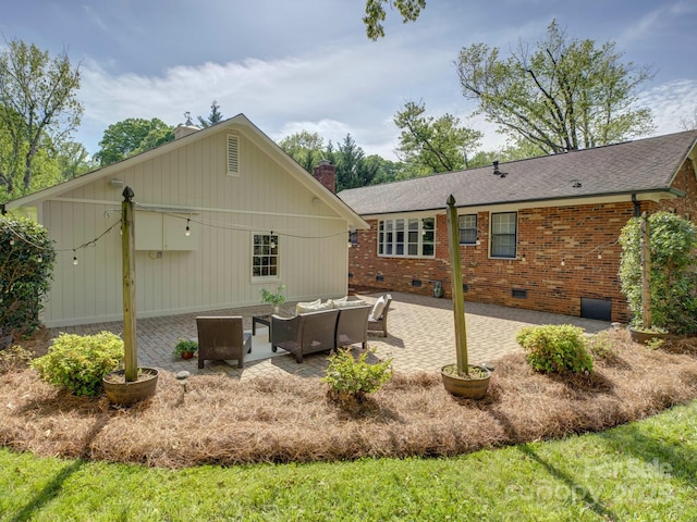 back of house with an outdoor living space, crawl space, a chimney, and a patio