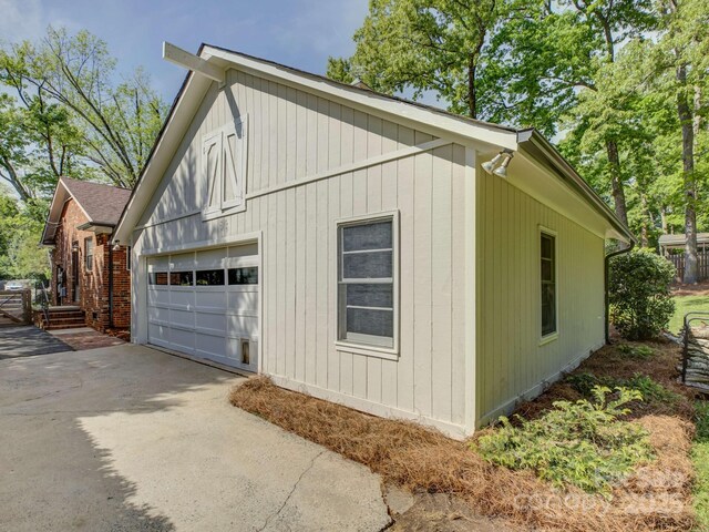 view of home's exterior with a detached garage