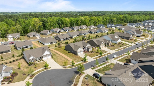 aerial view featuring a residential view and a wooded view