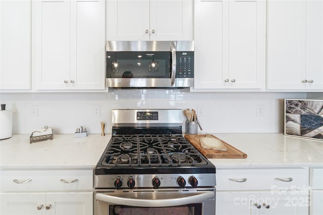 15520 Capps Rd, Charlotte, NC 28278 - kitchen featuring stainless steel appliances, white cabinets, backsplash, and light stone counters
