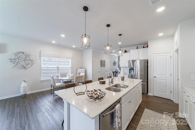 15520 Capps Rd, Charlotte, NC 28278 - kitchen with appliances with stainless steel finishes, a sink, dark wood-type flooring, white cabinets, and a center island with sink