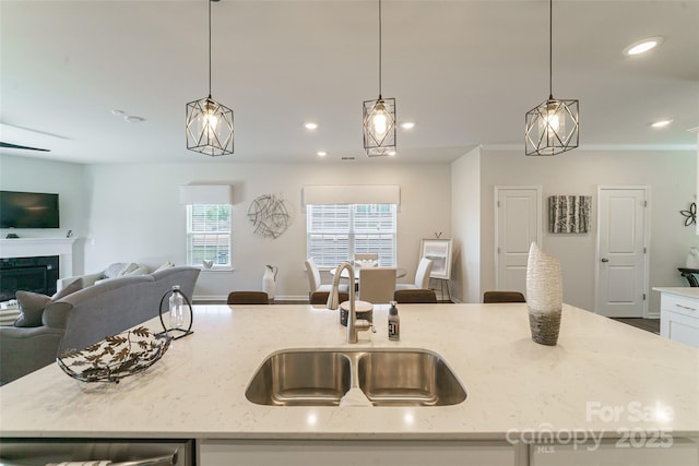 15520 Capps Rd, Charlotte, NC 28278 - kitchen featuring open floor plan, a sink, light stone countertops, hanging light fixtures, and recessed lighting