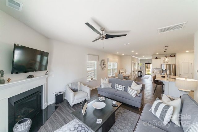 15520 Capps Rd, Charlotte, NC 28278 - living area featuring a ceiling fan, dark wood finished floors, recessed lighting, a glass covered fireplace, and baseboards