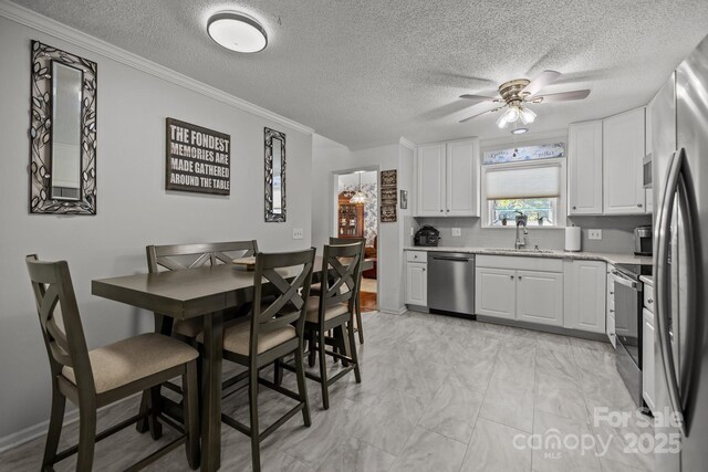 16070 Palawan Ct, Tega Cay, SC 29708 - kitchen with ceiling fan, appliances with stainless steel finishes, marble finish floor, and a textured ceiling
