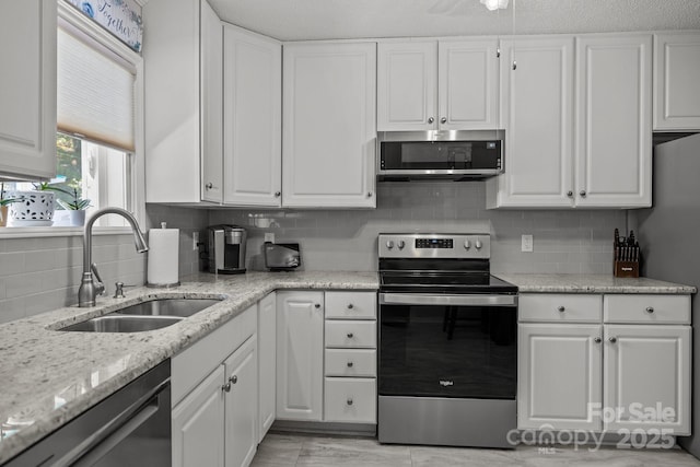 16070 Palawan Ct, Tega Cay, SC 29708 - kitchen with white cabinets, stainless steel appliances, and a sink