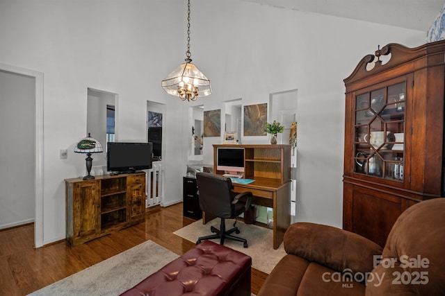 16070 Palawan Ct, Tega Cay, SC 29708 - home office featuring a high ceiling, a notable chandelier, wood finished floors, and baseboards