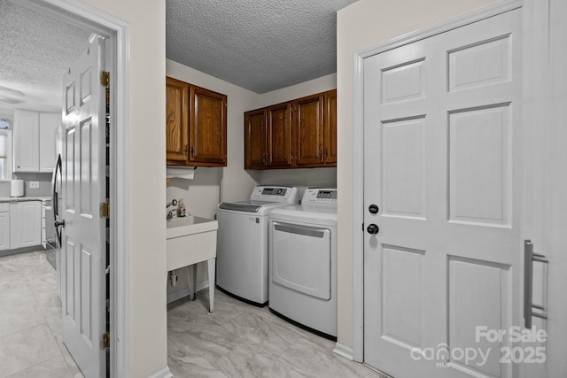 16070 Palawan Ct, Tega Cay, SC 29708 - laundry area with washing machine and clothes dryer, cabinet space, and a textured ceiling