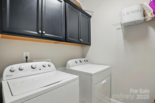 clothes washing area featuring cabinet space and separate washer and dryer