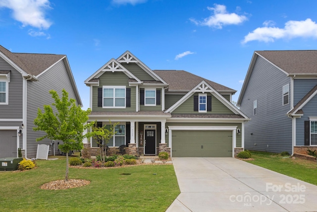 craftsman inspired home with concrete driveway, roof with shingles, a porch, and a front yard