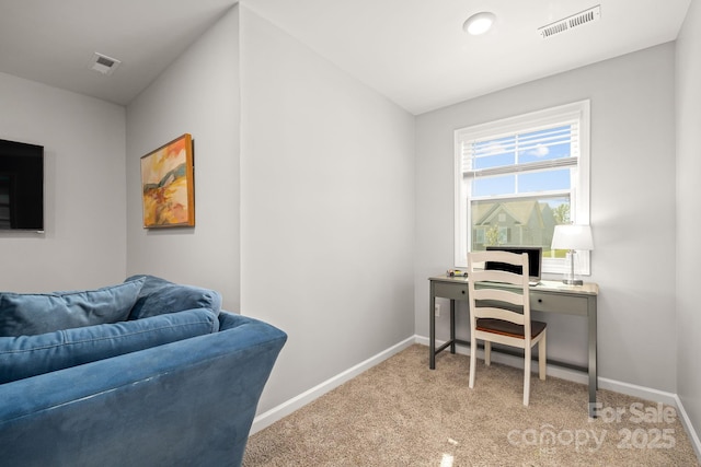 office space with visible vents, baseboards, and light carpet