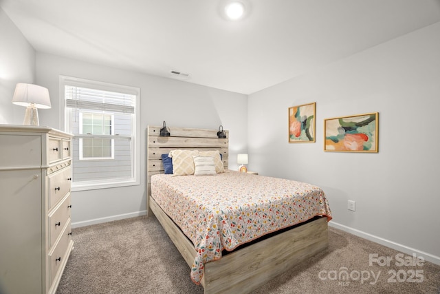 carpeted bedroom with baseboards and visible vents