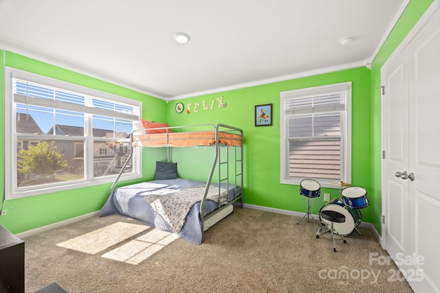 unfurnished bedroom featuring crown molding, carpet, and baseboards
