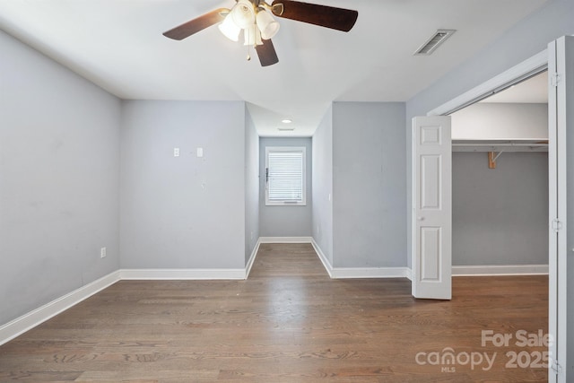 1592 Farmington Hills Dr, Conover, NC 28613 - interior space featuring wood finished floors, visible vents, a closet, baseboards, and ceiling fan