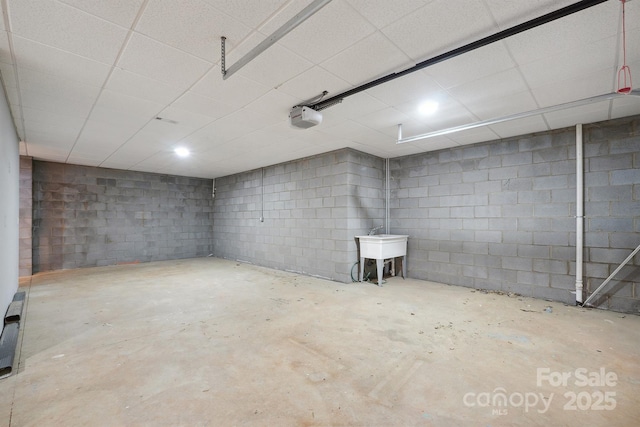1592 Farmington Hills Dr, Conover, NC 28613 - unfinished below grade area featuring concrete block wall, a paneled ceiling, and a sink